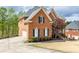 Spacious brick home with an attached garage, driveway, and well-maintained landscaping, providing both convenience and curb appeal at 4020 Balleycastle Ln, Duluth, GA 30097
