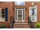 Welcoming front entrance featuring a decorative glass door, brick steps, and black wrought iron railings at 4020 Balleycastle Ln, Duluth, GA 30097