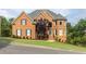 Brick home boasts meticulous landscaping, a charming turret, and stately curb appeal at 4020 Balleycastle Ln, Duluth, GA 30097