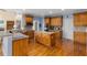 Spacious kitchen boasts hardwood floors, a center island, and stainless steel appliances at 4020 Balleycastle Ln, Duluth, GA 30097