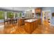 Eat-in kitchen showcases hardwood floors, center island, and lots of natural light at 4020 Balleycastle Ln, Duluth, GA 30097