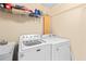 Bright laundry room with a sink, washing machine, dryer and white walls at 4020 Balleycastle Ln, Duluth, GA 30097
