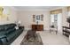 Comfortable living room with plush seating, a neutral color palette, and ample natural light from the large windows at 4020 Balleycastle Ln, Duluth, GA 30097