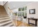 Bright living room with high ceilings, large windows, staircase and view to open kitchen and living spaces at 4020 Balleycastle Ln, Duluth, GA 30097