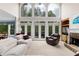 Bright living room featuring large windows, a fireplace, and comfortable seating, perfect for relaxation at 4020 Balleycastle Ln, Duluth, GA 30097
