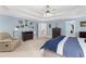 Open primary bedroom with tray ceiling, carpet floors, and furniture at 4020 Balleycastle Ln, Duluth, GA 30097