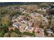 An aerial shot showcases a well-planned residential neighborhood with mature trees and lush landscaping at 4020 Balleycastle Ln, Duluth, GA 30097