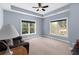 Comfortable sitting room with a ceiling fan, two windows, and a leather sofa at 4020 Balleycastle Ln, Duluth, GA 30097