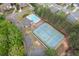 Aerial view of community's recreational amenities, including pool and tennis courts surrounded by lush greenery at 4020 Balleycastle Ln, Duluth, GA 30097