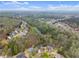 Aerial view of a neighborhood with lush greenery and a small lake at 5950 Bridge Stone Ct, Cumming, GA 30028