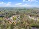 Sprawling aerial view of a neighborhood, showcasing mature trees and well-maintained homes at 5950 Bridge Stone Ct, Cumming, GA 30028