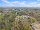 An aerial view of a new neighborhood surrounded by mature trees and foliage at 5950 Bridge Stone Ct, Cumming, GA 30028