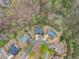 Aerial view of homes in a wooded neighborhood at 5950 Bridge Stone Ct, Cumming, GA 30028