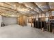 Unfinished basement with exposed wood beams and concrete floor, ready for customization at 5950 Bridge Stone Ct, Cumming, GA 30028