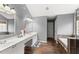 Bright bathroom featuring double sinks and a soaking tub at 5950 Bridge Stone Ct, Cumming, GA 30028