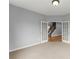 Spacious bedroom with neutral carpet and french doors with a view of the stairwell at 5950 Bridge Stone Ct, Cumming, GA 30028