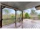 Covered wood deck with dark railings overlooking wooded backyard at 5950 Bridge Stone Ct, Cumming, GA 30028