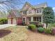 Charming two-story home with brick and stone accents, well-manicured landscaping, and a two-car garage at 5950 Bridge Stone Ct, Cumming, GA 30028