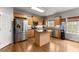 Well-lit kitchen with stainless steel appliances, an island, and wood cabinets at 5950 Bridge Stone Ct, Cumming, GA 30028