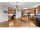 Spacious kitchen with stainless steel appliances, wood cabinets, and adjacent living room at 5950 Bridge Stone Ct, Cumming, GA 30028