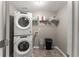 A tidy laundry room featuring a stacked washer and dryer unit, with shelving at 5950 Bridge Stone Ct, Cumming, GA 30028