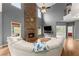 Spacious living room with a stone fireplace, wood floors, and lots of natural light at 5950 Bridge Stone Ct, Cumming, GA 30028