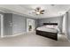 Spacious main bedroom with a tray ceiling, carpeted floor, and ample natural light at 5950 Bridge Stone Ct, Cumming, GA 30028