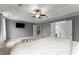 Bright main bedroom featuring plush carpeting and a ceiling fan at 5950 Bridge Stone Ct, Cumming, GA 30028