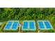 Aerial view of the community tennis courts surrounded by beautiful landscaping and trees at 5950 Bridge Stone Ct, Cumming, GA 30028