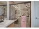 This bathroom features a large walk-in shower with a glass door, shower seat, grab bars, and pink towels at 338 Oak Leaf Pl, Acworth, GA 30102