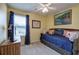 Cozy bedroom features a trundle bed, ceiling fan, and warm, inviting yellow walls at 338 Oak Leaf Pl, Acworth, GA 30102