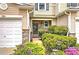 Charming townhome featuring a welcoming entrance with beautiful landscaping and a one-car garage at 338 Oak Leaf Pl, Acworth, GA 30102