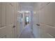 Well-lit hallway with multiple doors leading to various rooms in the home at 338 Oak Leaf Pl, Acworth, GA 30102