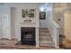 Interior view of a staircase and fireplace in a home with neutral tones and hardwood flooring at 338 Oak Leaf Pl, Acworth, GA 30102