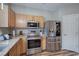 Kitchen featuring stainless steel appliances, wooden cabinets, granite countertops and hardwood flooring at 338 Oak Leaf Pl, Acworth, GA 30102