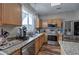 Kitchen featuring stainless steel appliances, wooden cabinets, granite countertops and decorative lighting at 338 Oak Leaf Pl, Acworth, GA 30102
