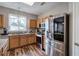 Kitchen featuring stainless steel appliances, wooden cabinets, granite countertops and decorative lighting at 338 Oak Leaf Pl, Acworth, GA 30102