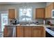 Kitchen featuring stainless steel appliances, wooden cabinets, granite countertops and access to the backyard at 338 Oak Leaf Pl, Acworth, GA 30102