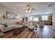 Spacious living room with wood floors, ceiling fan, and ample seating for relaxing at 338 Oak Leaf Pl, Acworth, GA 30102