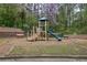 Charming playground with a slide, stairs, and climbing structure amidst a natural setting at 338 Oak Leaf Pl, Acworth, GA 30102