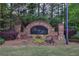 Elegant brick sign marking the entrance to Ridge Mill, enhanced by colorful flowerbeds and lush greenery at 338 Oak Leaf Pl, Acworth, GA 30102