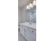 Bright bathroom features sleek vanity with ample storage and a large mirror reflecting natural light at 4265 Easter Lily Ave, Buford, GA 30519