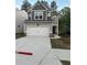 Charming two-story home featuring a gray exterior, attached garage, and well-manicured lawn at 4265 Easter Lily Ave, Buford, GA 30519