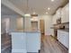 Contemporary kitchen featuring an island, white cabinets, and stainless steel appliances at 4265 Easter Lily Ave, Buford, GA 30519