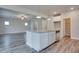 Open concept kitchen with an island, stainless steel dishwasher, and a view of the living area at 4265 Easter Lily Ave, Buford, GA 30519