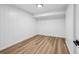 Finished basement area with neutral paint, wood-look flooring, and recessed lighting for versatile use at 6124 Kings Mountain Ct, Stone Mountain, GA 30087