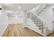Finished basement area features new flooring, stylish staircase, and fresh white walls at 6124 Kings Mountain Ct, Stone Mountain, GA 30087