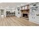 Basement living area boasts a brick fireplace, built-in shelves, and a wet bar area at 6124 Kings Mountain Ct, Stone Mountain, GA 30087