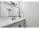 Bathroom features a modern vanity with gray cabinets, white countertop, and black fixtures at 6124 Kings Mountain Ct, Stone Mountain, GA 30087