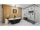 Spa-like bathroom featuring a soaking tub, walk-in shower, and decorative window at 6124 Kings Mountain Ct, Stone Mountain, GA 30087